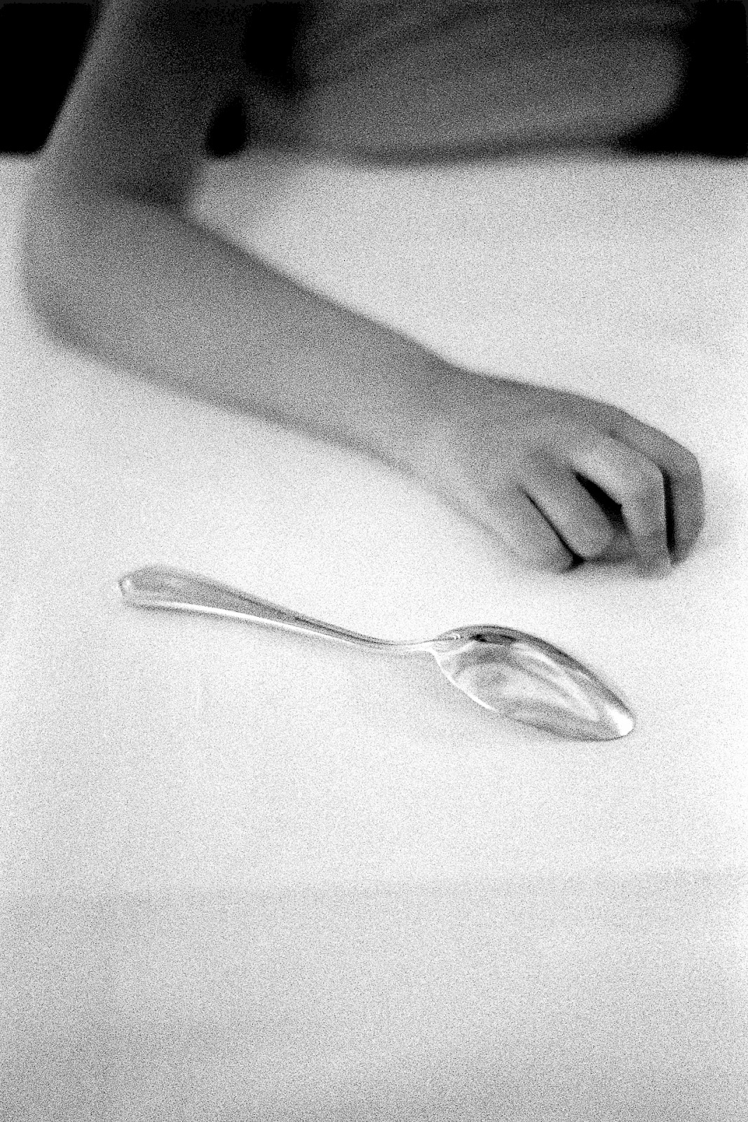 Untitled (hand and spoon), silver gelatin photograph by Mikael Siirilä